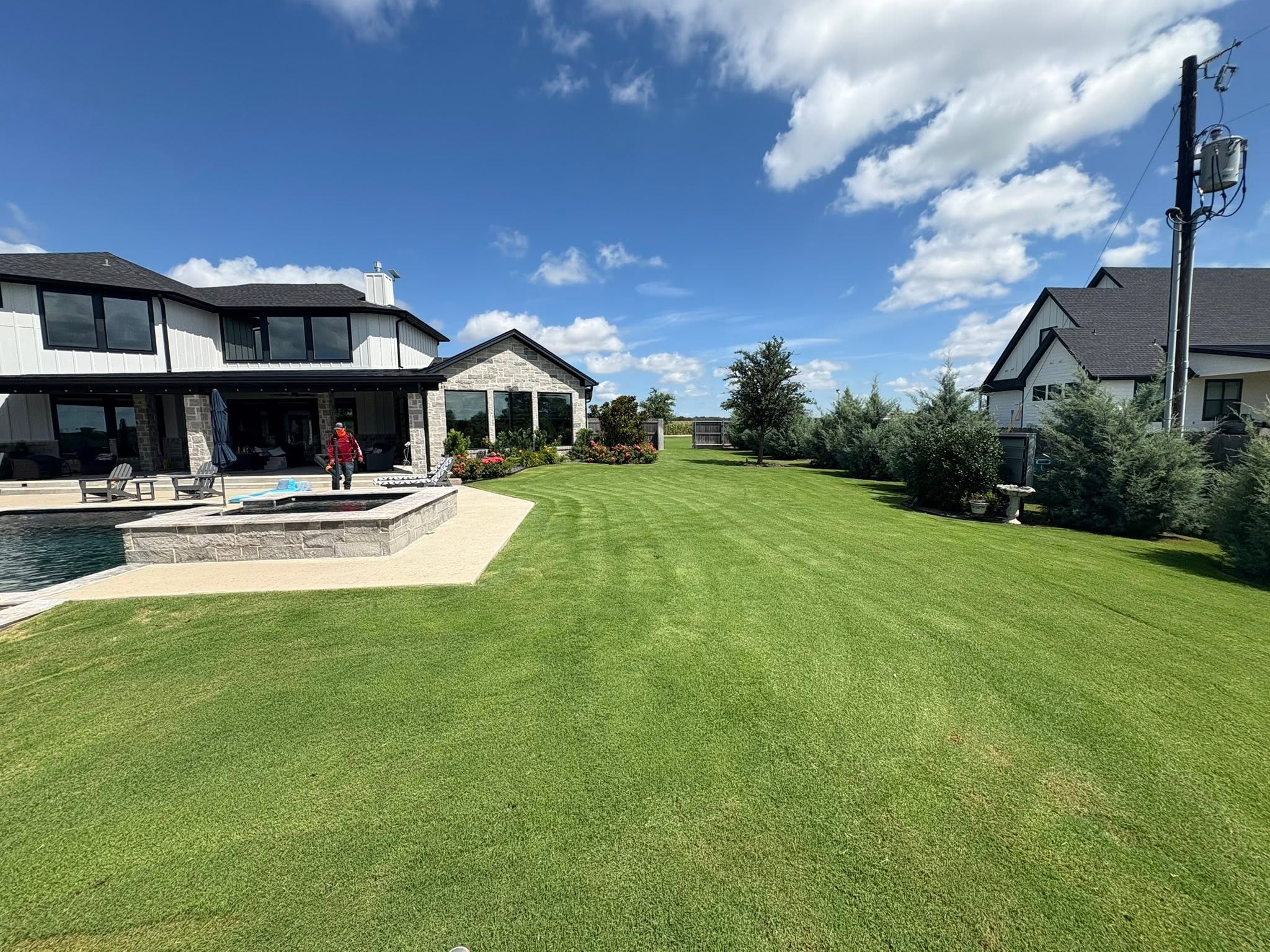 Freshly striped lawn beside a pool in Waco